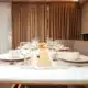 3 days shared trip. Elegant dining table set with fine china, glassware, and a centerpiece of fresh fruit, surrounded by warm curtains.